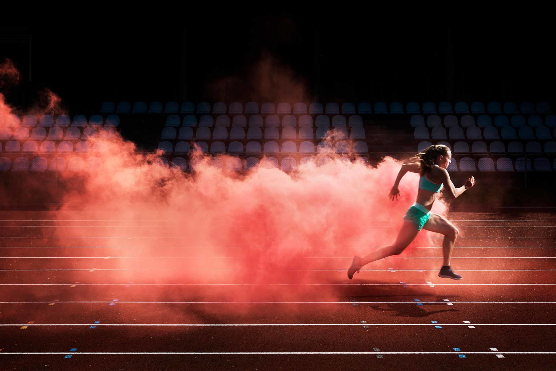 athlete running red smoke